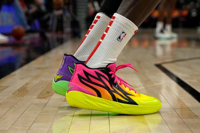 View of pink and yellow Puma shoes.